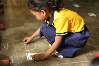 Child playing on the floor - courtesy of Pratham
