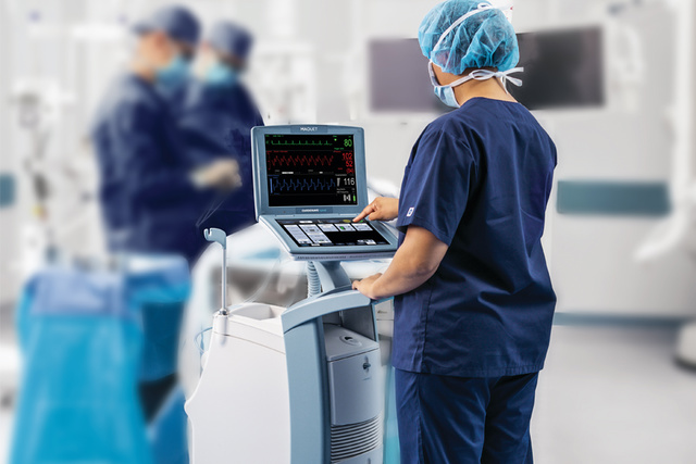 Nurse using Cardiosave to monitor patient in operating theater environment 
