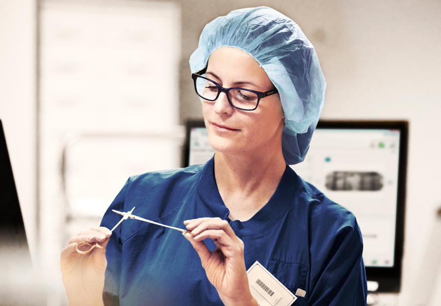 Nurse inspecting sterilized instruments