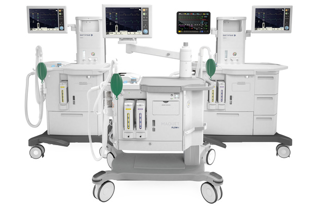 Three medical anesthesia machines with digital screens and various attachments on wheels.