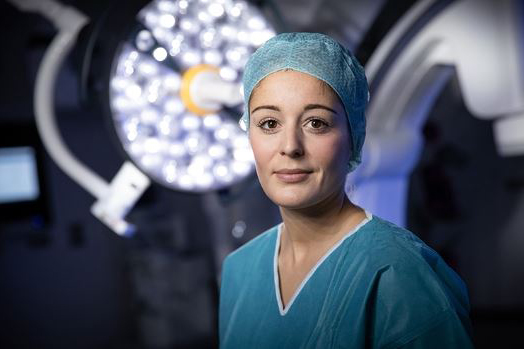 Woman in medical uniform looking straight