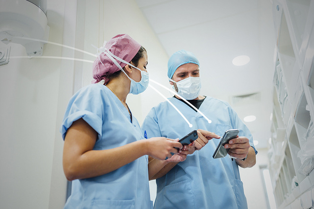 Two healthcare professionals chaecking Talis data on the mobile phones