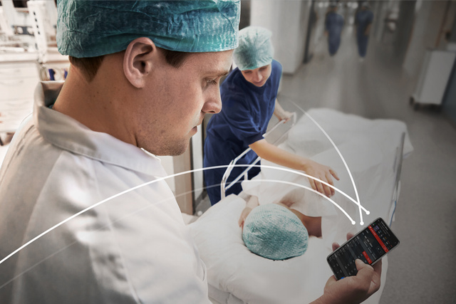 Caregiver checking Talis smart data his mobile phone