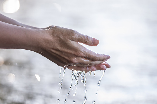 Hands with trickling water