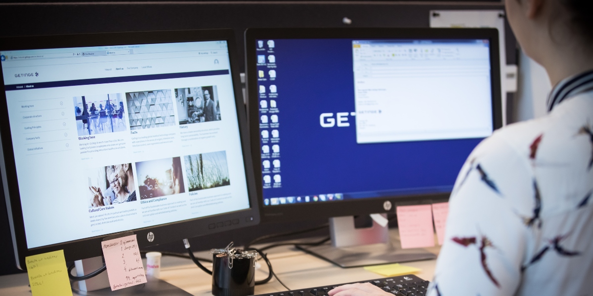 Woman works with two monitors Woman works with two monitors