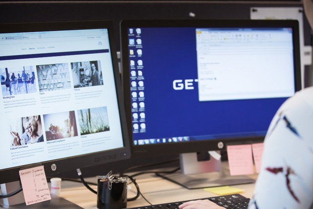 Woman works with two monitors