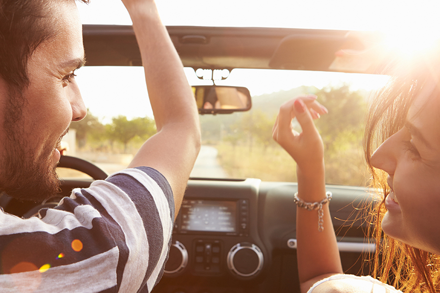 Smiling couple riding a car