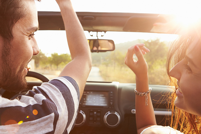 Smiling couple riding a car