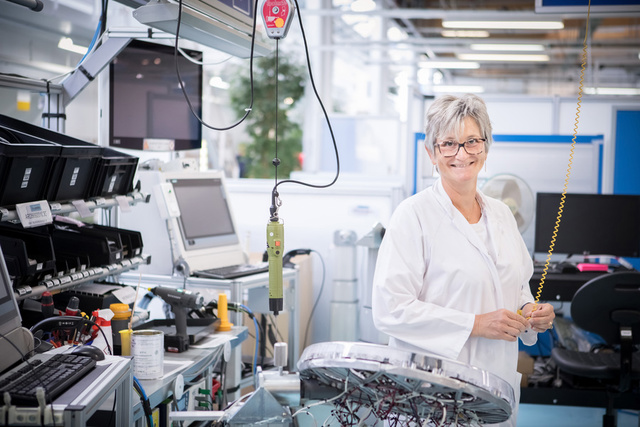 Woman smiling in LED workspace