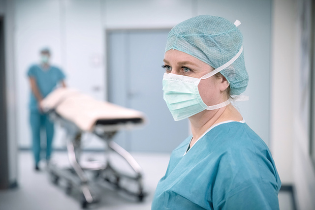 Nurse with a mask and a medical cap