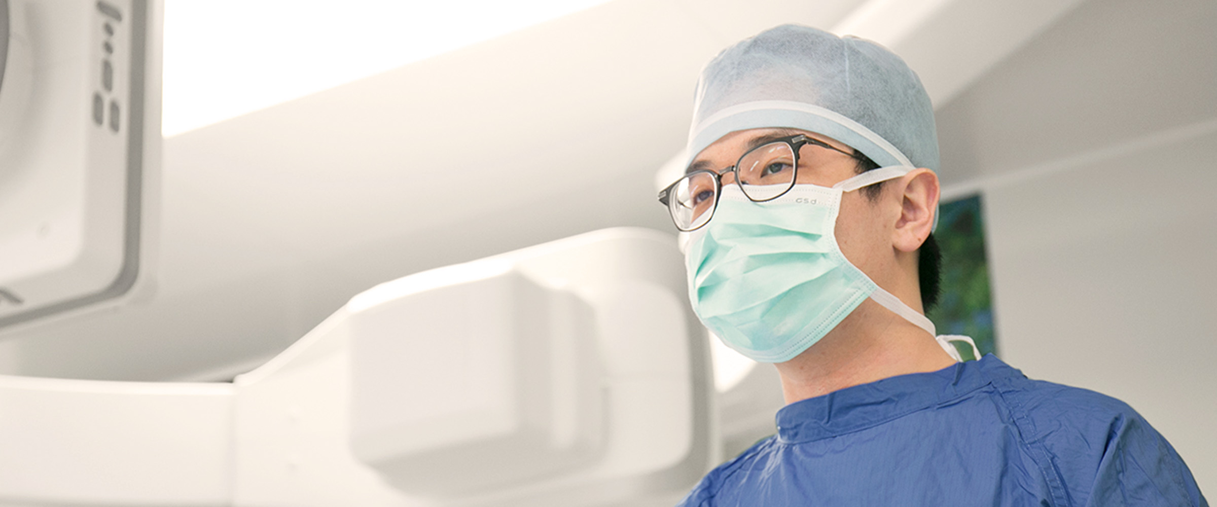 Man with glasses and medical mask and cap