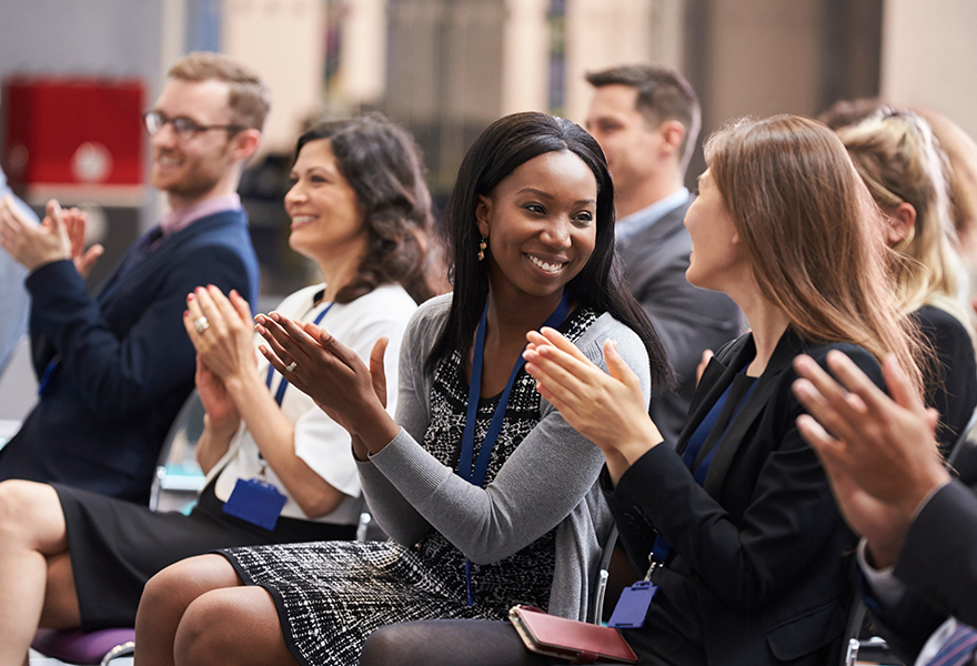 People smiling and clapping their hands