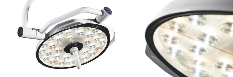 金属製躯体に複数の電球が入った丸型 LED 手術用照明器、Maquet Ezea。白い背景に対して斜めから近づいて撮影されています