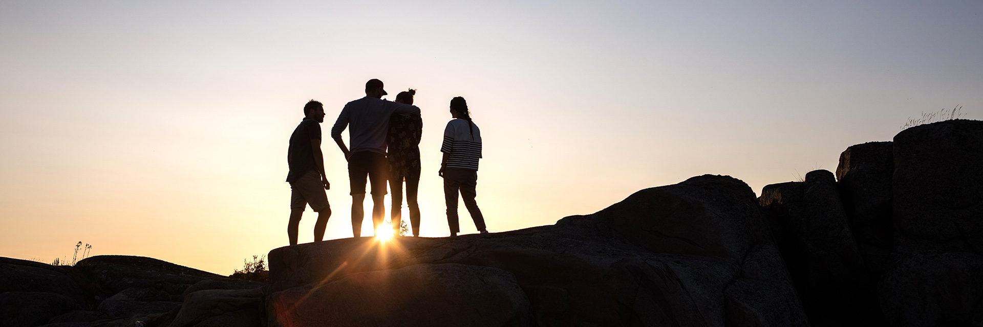 People on a hill during sunset