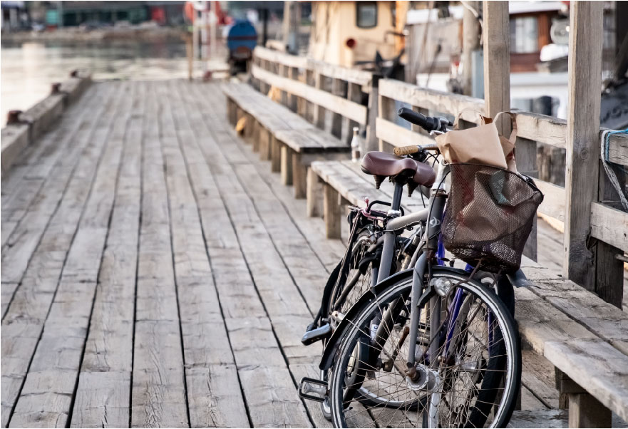 bicycles on a deck near water bicycles on a deck near water