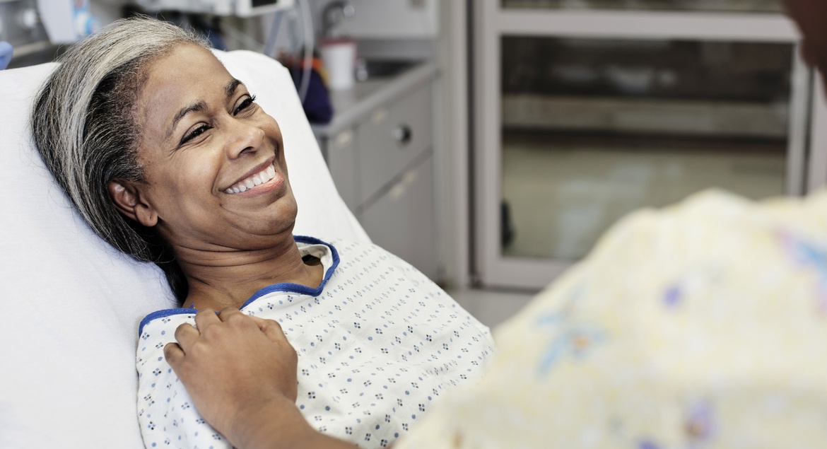 Patient laying in hospital room smiling