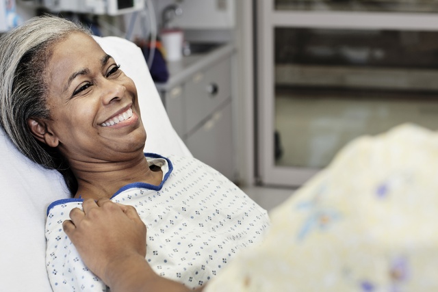 Patient laying in hospital room smiling