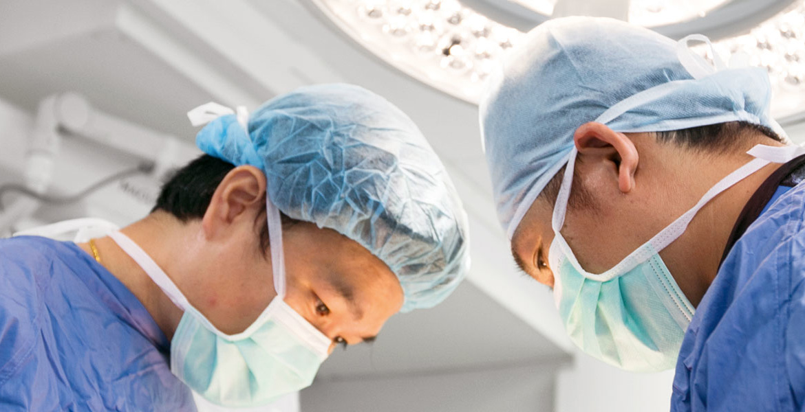 Surgeons working in operating room