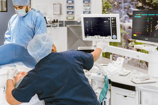 Patient under anesthesia with caregivers