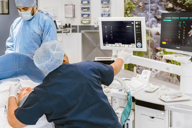Patient under anesthesia with caregivers