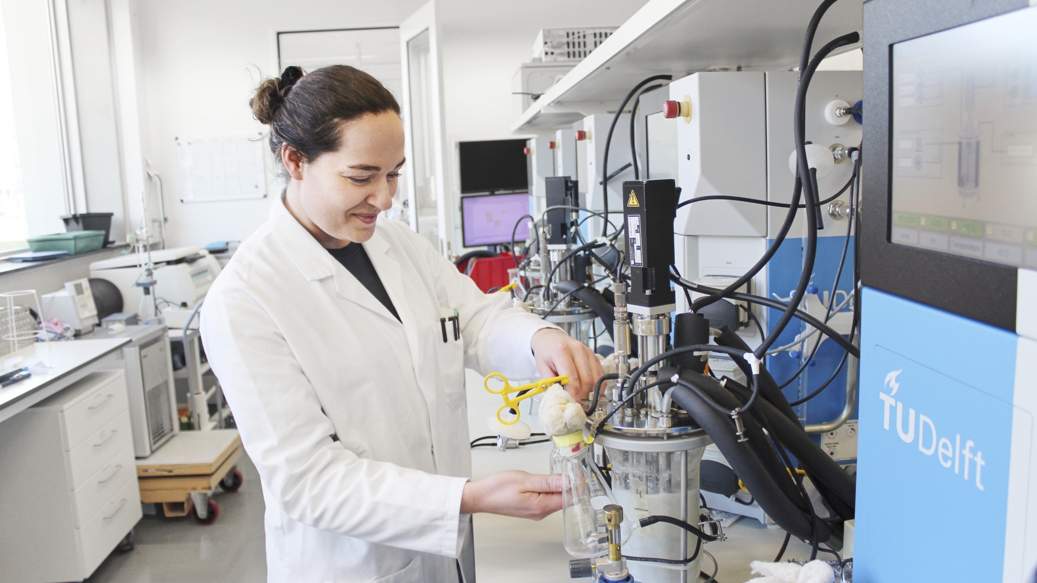 Woman working in laboratory  on a bioreactor 