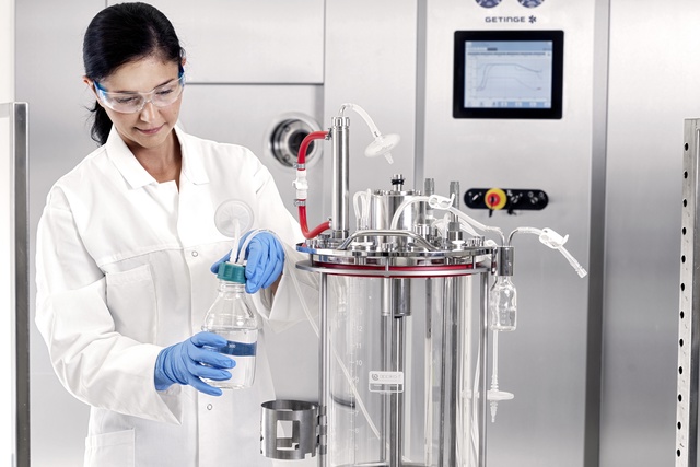 Woman working on a multi use bioreactor 