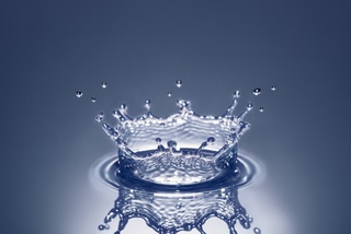 Waterdrop falling on water surface