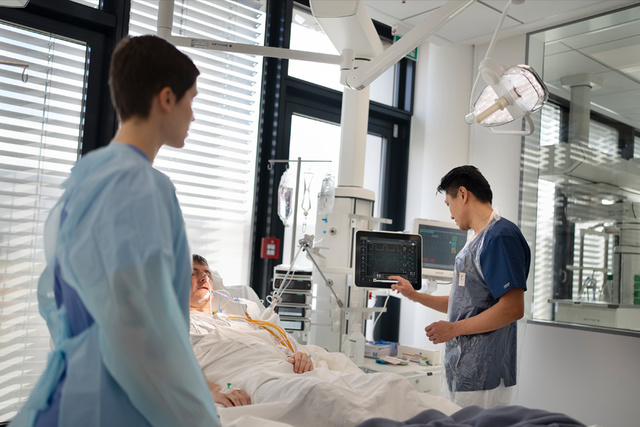 Servo-u in clinical environment with two clinicians and an adult patient