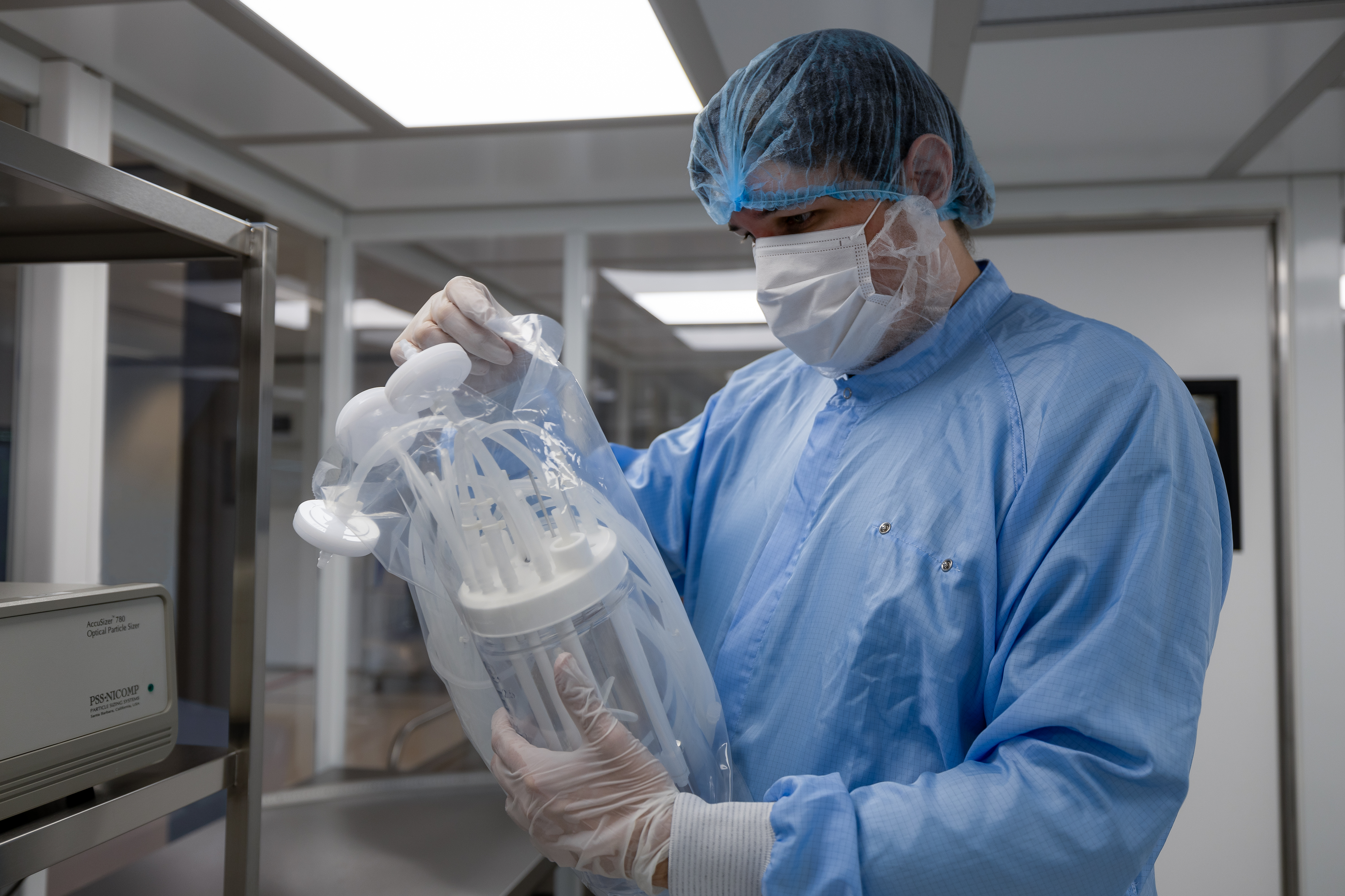 Scientist in cleanroom with the single-use bioreactor AppliFlex ST GMP