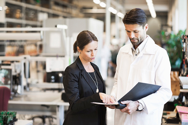 Businesswoman and engineer discussing