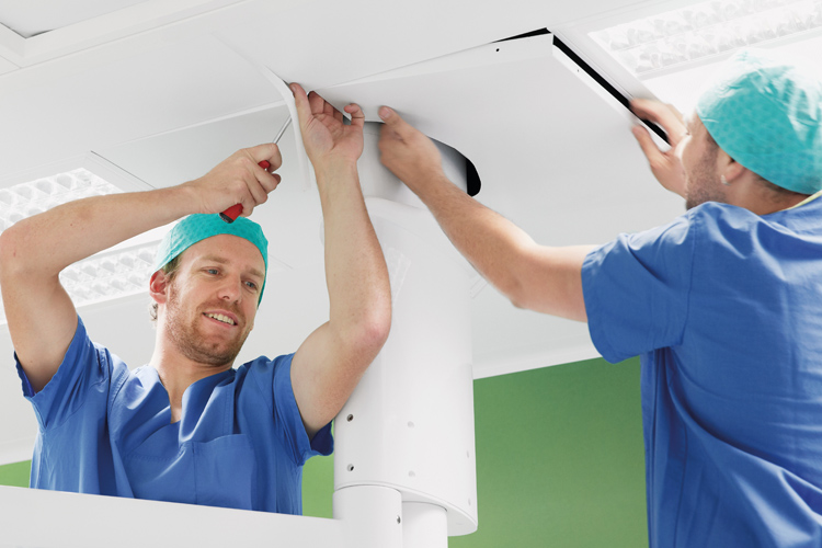 Two men installing ceiling elements Two men installing ceiling elements