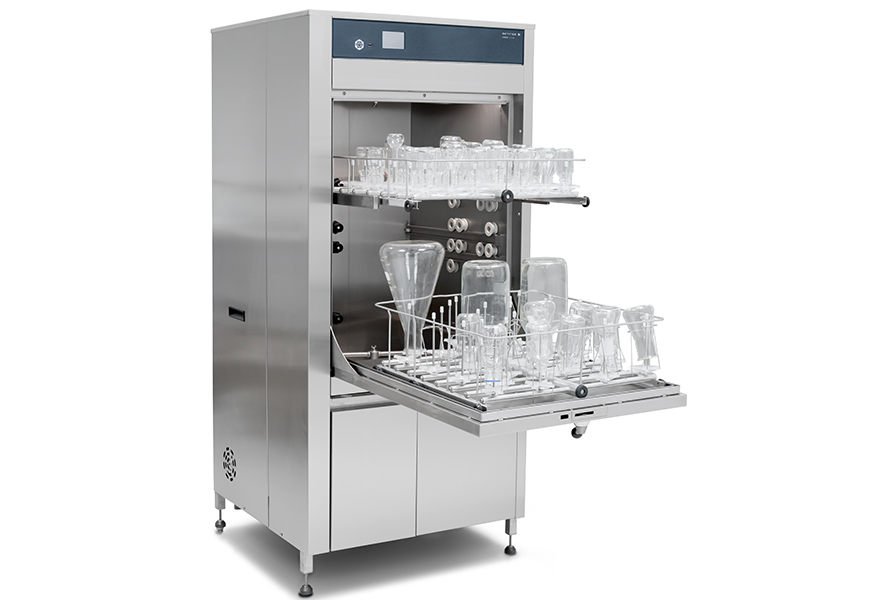 Laboratory glassware washer with open door, displaying racks of various clean glass vessels and equipment.