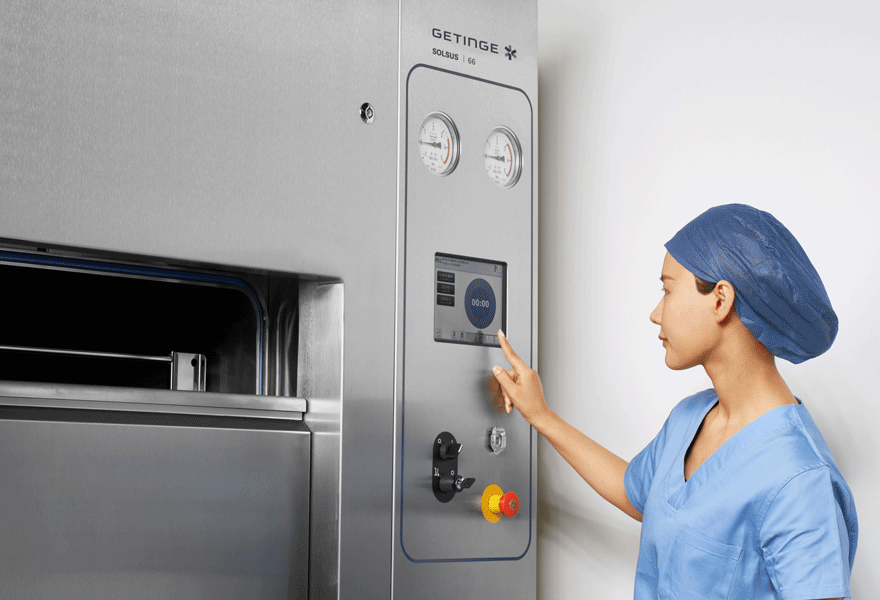 Operator clicking on an easy to use control panel for Getinge Solsus 66 steam sterilizer