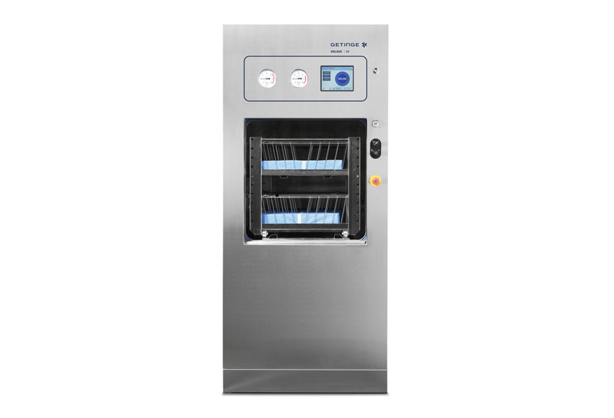 Getinge Solsus 66 steam sterilizer with open chamber showing wire baskets on a shelf rack Getinge Solsus 66 steam sterilizer with open chamber showing wire baskets on a shelf rack