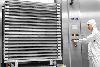 GEV Steam/Air Mixture Sterilizer with biopharma at customer site with a man working next to it