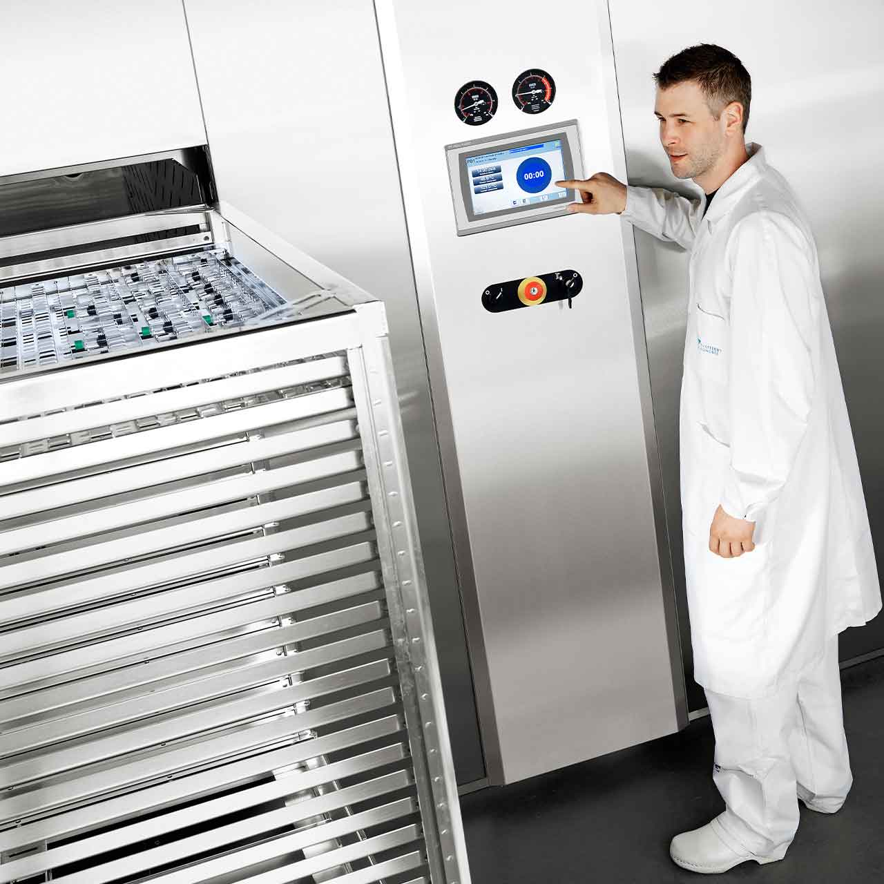 GEV Sterilizer with a man next to it that touches the display for monitoring GEV Sterilizer with a man next to it that touches the display for monitoring