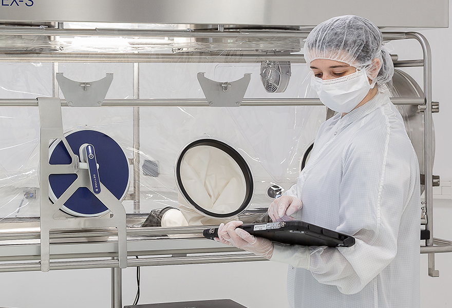 An operator using a Glove Leak Tester to test the isolator glove and sleeve integrity An operator using a Glove Leak Tester to test the isolator glove and sleeve integrity
