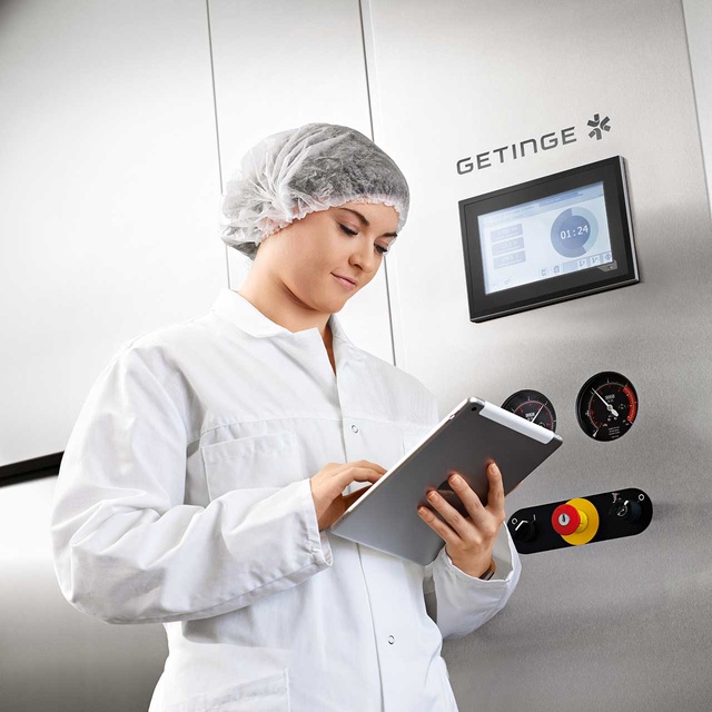 GSS R Steam Sterilizer for Lab and Biomedical research with B&R control system and a woman working next to it