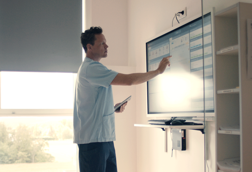 Nurse is working in INSIGHT the patient flow management solution on touchscreens Nurse is working in INSIGHT the patient flow management solution on touchscreens