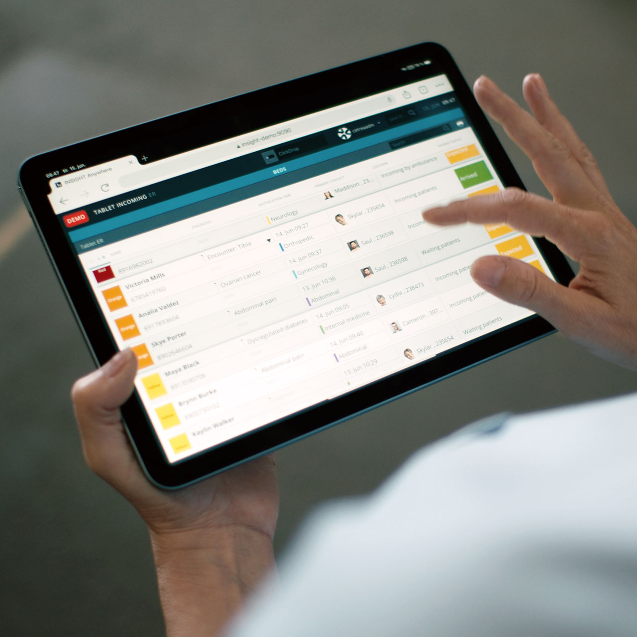 Nurse using INSIGHT patient flow management solution on a tablet to manage the patient flow from arrival to discharge