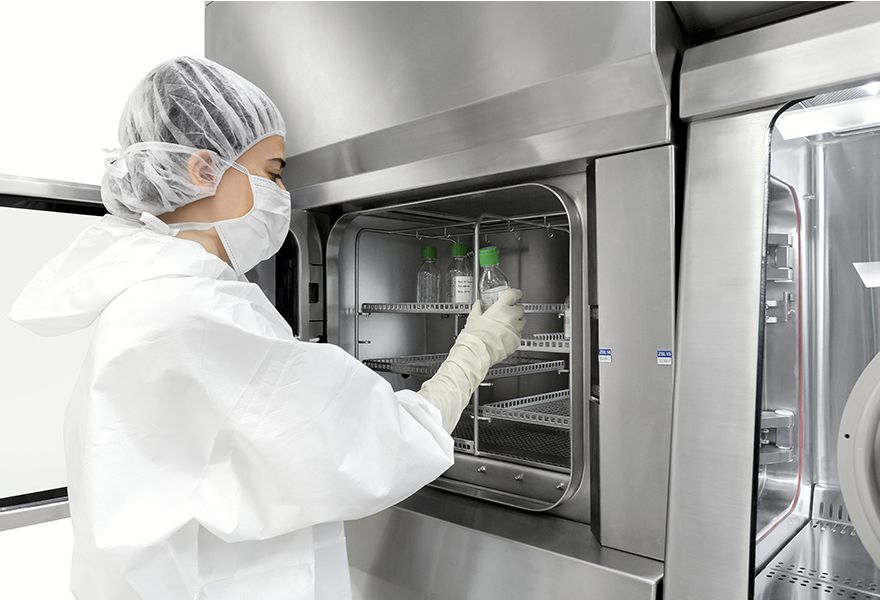 An operator loading an ISOFLEX-R isolator hatch An operator loading an ISOFLEX isolator hatch