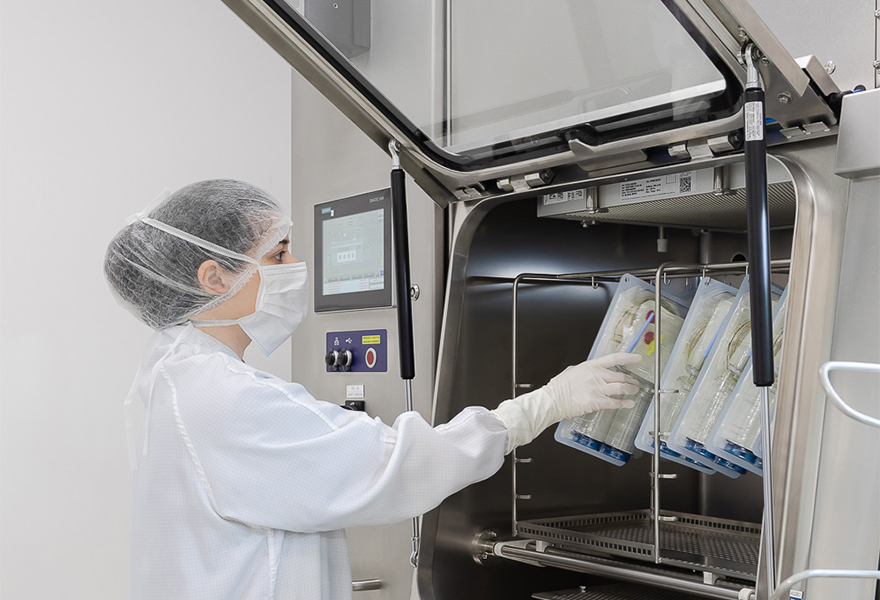 Operator loading the ISOPRIME isolator's transfer hatch