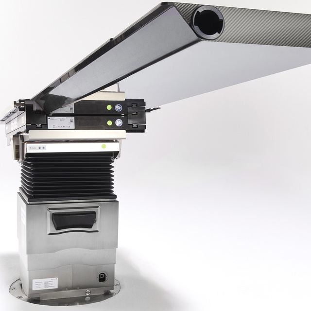 Mechanical structure with a long, rectangular, metallic component extending forwards, supported by a sturdy base.