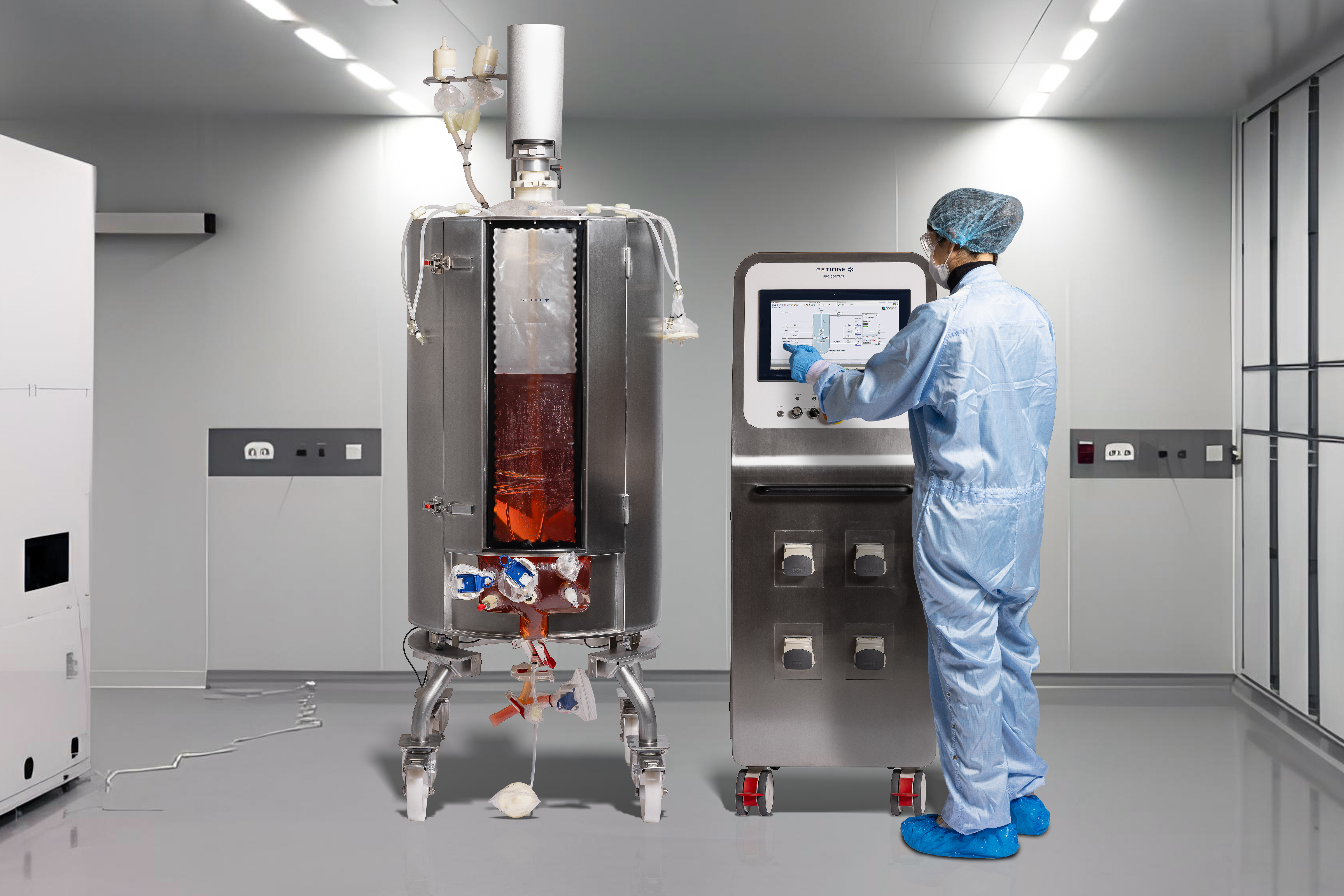 Operator performing cultivations in the cleanroom with the single-use production bioreactor and Pro-Control