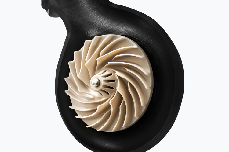 A black turbine housing showcasing a metallic, spiral turbine wheel against a white background.