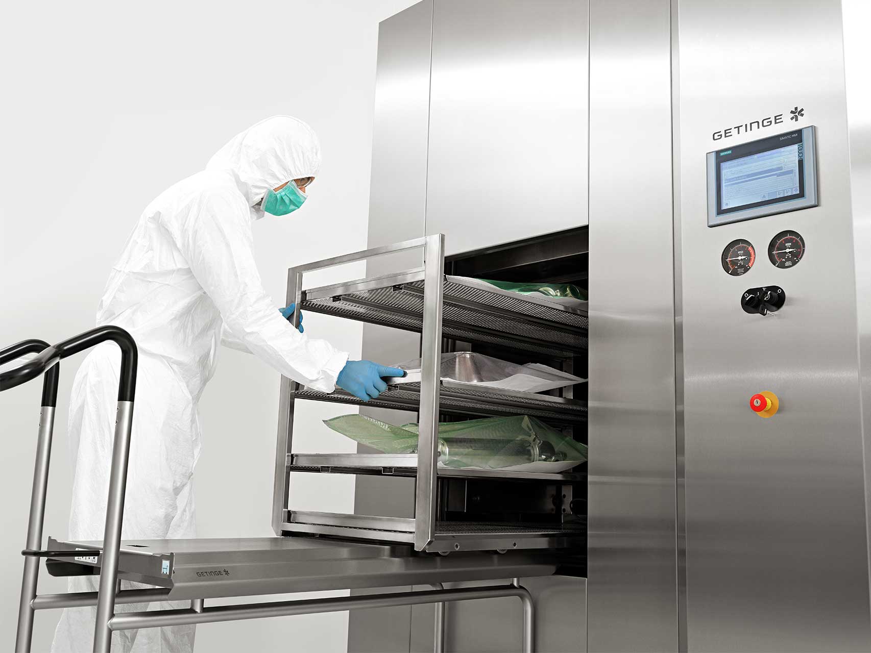 A man is loading the GSS Steam Sterilizer with equipment for biopharmaceutical production 