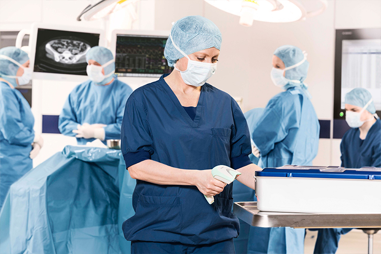 OR nurse scanning instruments into T-DOC OR nurse scanning instruments into T-DOC