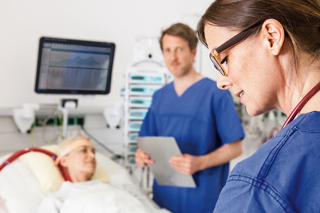 ECMO patient in ICU bed with clinicians