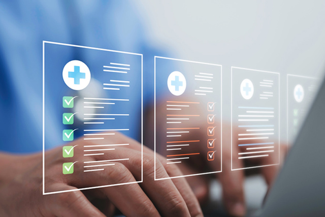 A person types on a laptop with digital medical records featuring Talis checklists displayed in front of them.