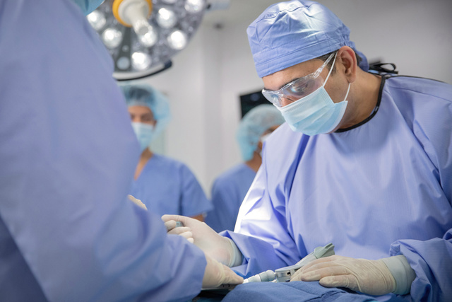 Clinician performing heart surgery
